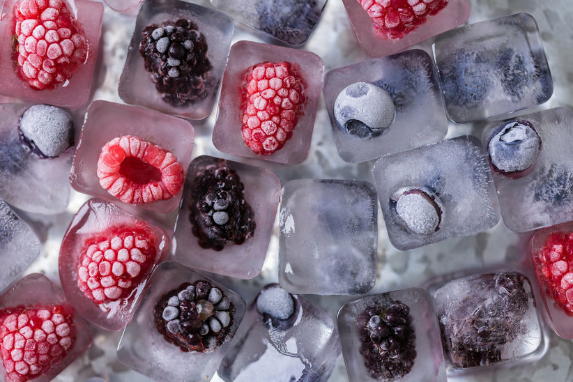 Fruit frozen in ice cubes with blackberries, blueberries, and raspberries